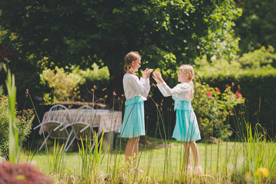 Cute siblings playing on grassy fields