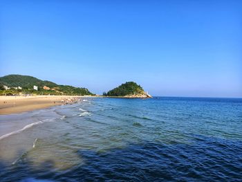 Scenic view of sea against clear blue sky