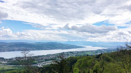 Scenic view of sea and mountains against sky