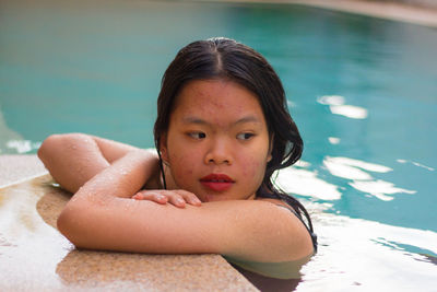 Portrait of asian woman standing on the edge of pool