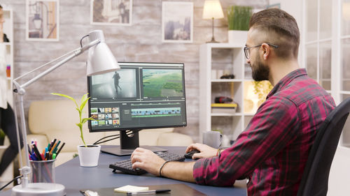 Side view of young man working in office