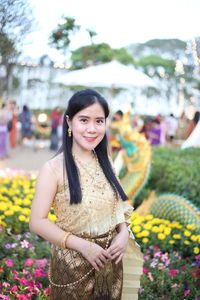 Portrait of smiling woman wearing traditional clothing standing outdoors