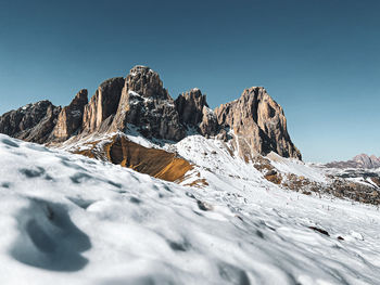 Scenic view of snowcapped mountains against clear blue sky