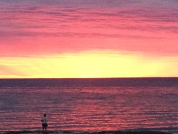 Scenic view of sea against sky at sunset