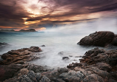 Scenic view of sea against cloudy sky
