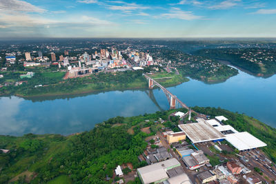 High angle view of river and cityscape against sky