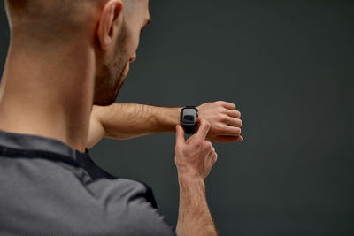 Cropped hand of man against black background