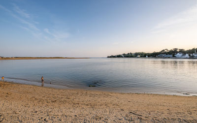 Scenic view of beach against sky during sunset