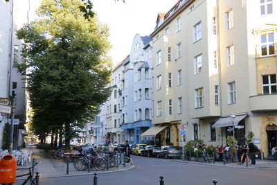 People on street amidst buildings in city