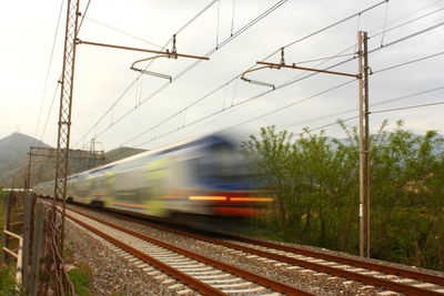 Railroad tracks by train against sky