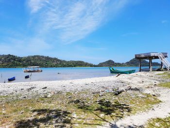 Scenic view of beach against blue sky