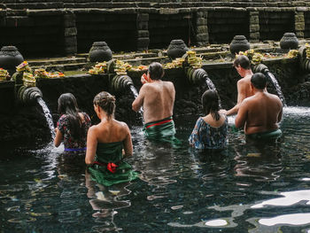 Rear view of people enjoying in temple