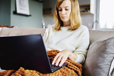 Woman working at home with laptop