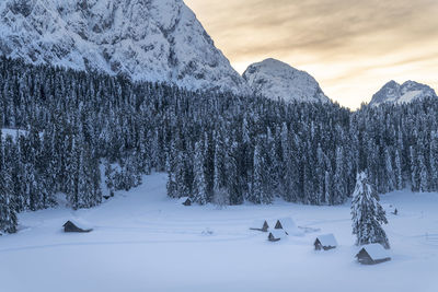 Scenic view of snow covered field against mountains