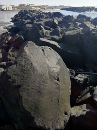 Aerial view of rock formation on beach against sky