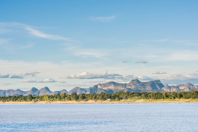 Scenic view of sea and mountains against sky