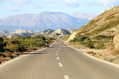 Road amidst mountains against sky