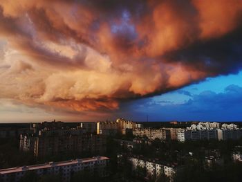 High angle view of buildings against dramatic sky