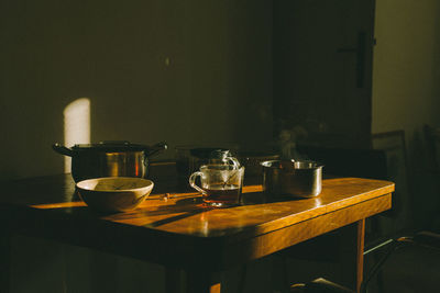 Breakfast with tea cups on the wooden table, early morning with hot food and drink.