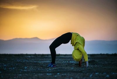 Silhouette of woman at sunset