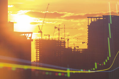 Low angle view of illuminated building against sky during sunset