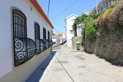 Footpath amidst buildings in city