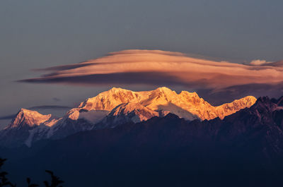 Scenic view of snowcapped mountains against sky during sunset