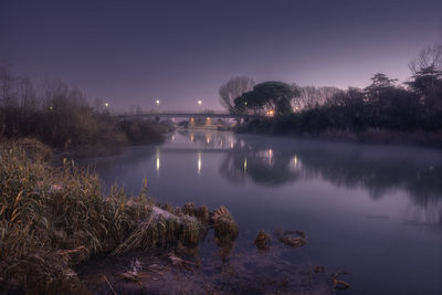 Scenic view of lake against sky at night