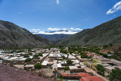 Scenic view of buildings and mountains against sky