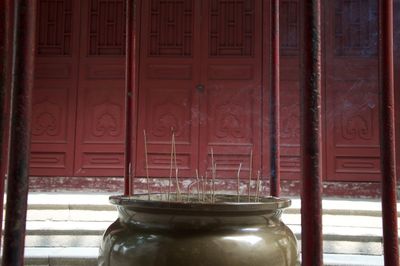 Close-up of jar on table against building