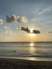 The beauty of sunset in kuta beach, bali with far away boat floating on the sea. 