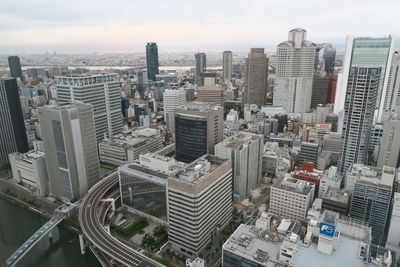High angle view of modern buildings in city against sky