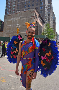 Full length of woman standing with multi colored umbrella