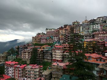 Buildings in town against sky