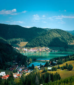 High angle view of townscape by sea against sky