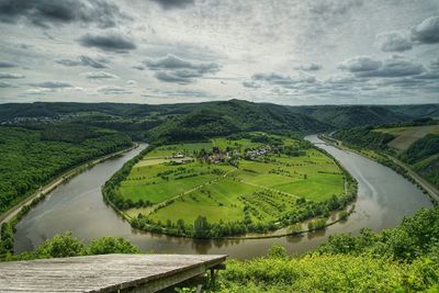 Scenic view of landscape and river against sky