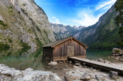 Scenic view of lake by mountains against sky