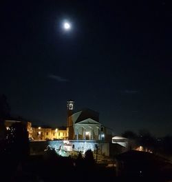 Illuminated city against sky at night