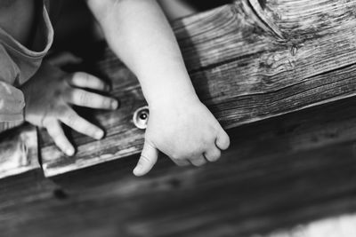 Close-up of baby hand on wood