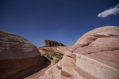 View of rock formations against blue sky