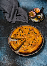 Delicious mango upside down cake with passion fruit and a piece cut off on a plate. summer dessert