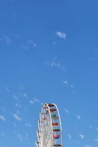 Low angle view of ferris wheel against sky