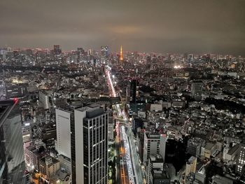 High angle view of illuminated city buildings at night