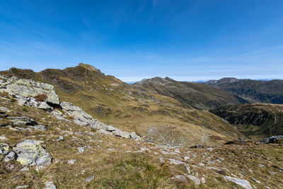 Scenic view of mountains against blue sky