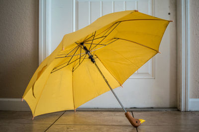 Low section of person with yellow umbrella