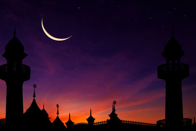 Silhouette dome mosques on twilight sky background and crescent moon