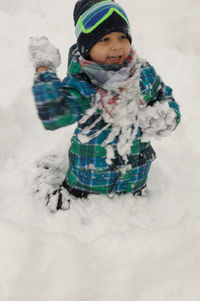 Happy child playing in snow