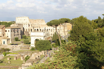 Aerial panoramic cityscape view of the roman forum and roman colosseum during sunset in rome, italy