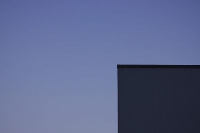 Low angle view of building corner against clear sky