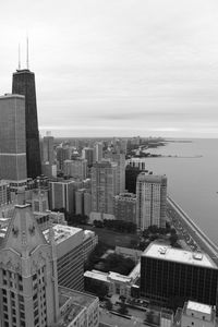 Aerial view of buildings in city against sky